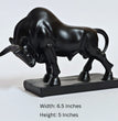 Black bull statue on a white background with dimensions displayed